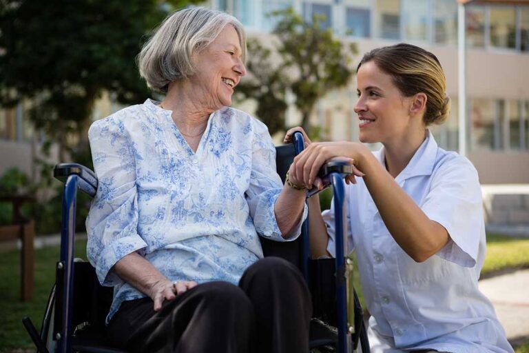Resident and family member review a care plan together at a quiet assisted living table.